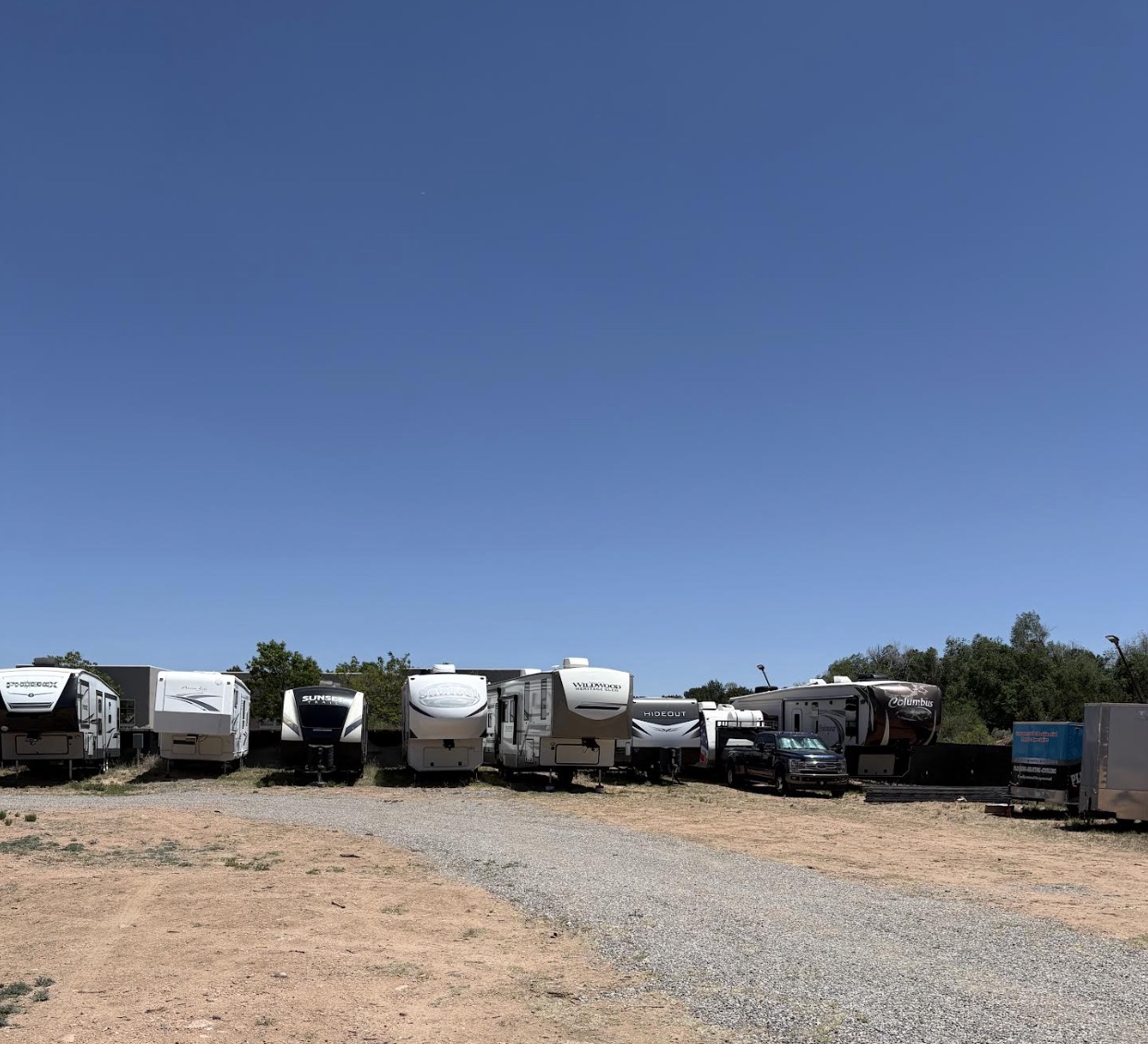 5th wheels and travel trailers with the Sangre de Cristo foothills beyond.